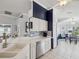 Bright kitchen features stainless steel appliances, mosaic backsplash, and white cabinetry at 11342 Hollander Ave, Hudson, FL 34667