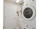 Functional laundry room with washer, dryer, storage shelves, and a convenient utility sink at 11342 Hollander Ave, Hudson, FL 34667