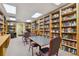 This library features walls of bookshelves and tables, inviting residents to relax and read at 11342 Hollander Ave, Hudson, FL 34667