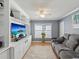 Comfortable living room with built-in shelving and a calming gray color scheme at 11342 Hollander Ave, Hudson, FL 34667