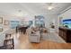 Open living room with hardwood floors, dining area, and comfortable seating at 11342 Hollander Ave, Hudson, FL 34667