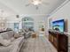 Bright living room featuring wood floors, neutral paint, and lots of seating at 11342 Hollander Ave, Hudson, FL 34667