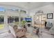 Cozy sun room featuring natural light, comfortable furniture, and access to the outdoors at 11342 Hollander Ave, Hudson, FL 34667