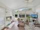 Bright sunroom with tiled floors, lots of windows, cozy seating and outdoor views at 11342 Hollander Ave, Hudson, FL 34667