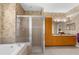 Bathroom with glass shower, soaking tub, dual sinks and vanity with linen cabinet at 11443 Marsh Creek Ct, New Port Richey, FL 34654