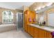 Bathroom with soaking tub, glass shower, dual sinks and large vanity with cabinet storage at 11443 Marsh Creek Ct, New Port Richey, FL 34654