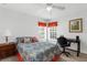Bedroom with lots of natural light, plush carpet, and a desk area at 11443 Marsh Creek Ct, New Port Richey, FL 34654