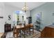 Formal dining room features natural light, an area rug, and seating for four at 11443 Marsh Creek Ct, New Port Richey, FL 34654