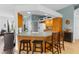 Kitchen area with a countertop bar and casual seating with easy access to other living spaces at 11443 Marsh Creek Ct, New Port Richey, FL 34654