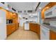 Bright kitchen with ample counter space, light wood cabinets, and modern appliances for culinary enthusiasts at 11443 Marsh Creek Ct, New Port Richey, FL 34654