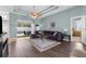 Cozy living room with hardwood floors, a ceiling fan, and sliding glass doors leading to the backyard at 11443 Marsh Creek Ct, New Port Richey, FL 34654