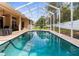 Enjoy a refreshing swim in this beautiful screened-in pool, perfect for relaxing and entertaining outdoors at 11443 Marsh Creek Ct, New Port Richey, FL 34654