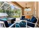 Enclosed pool area with outdoor seating, a waterfall feature, and a bar area at 11443 Marsh Creek Ct, New Port Richey, FL 34654