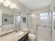 Bathroom featuring a shower, sink and mirror at 11512 Yellow Birch Ct, New Port Richey, FL 34654