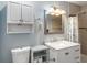 Bathroom featuring a white sink vanity and shower with patterned shower curtains at 11512 Yellow Birch Ct, New Port Richey, FL 34654