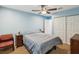 Comfortable bedroom featuring a large bed, ceiling fan, and ample closet space at 11512 Yellow Birch Ct, New Port Richey, FL 34654