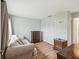 This bedroom offers wood floors, comfortable seating, and ample closet space at 11512 Yellow Birch Ct, New Port Richey, FL 34654