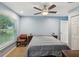 This bedroom features a ceiling fan and a bright window with natural light at 11512 Yellow Birch Ct, New Port Richey, FL 34654