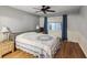 Comfortable bedroom featuring a bed, ceiling fan, and window with curtains at 11512 Yellow Birch Ct, New Port Richey, FL 34654