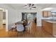 Dining room featuring wood floors and a stylish table with gray chairs at 11512 Yellow Birch Ct, New Port Richey, FL 34654