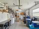 Spacious garage area with laundry units, overhead storage, work space, and access to the house at 11512 Yellow Birch Ct, New Port Richey, FL 34654