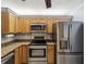 This renovated kitchen features stainless steel appliances and light wood cabinets at 11512 Yellow Birch Ct, New Port Richey, FL 34654