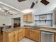 Well-lit kitchen featuring wood cabinets, stainless steel appliances, and granite countertops at 11512 Yellow Birch Ct, New Port Richey, FL 34654
