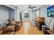 Spacious living room with hardwood floors and a ceiling fan, with a sliding door for natural light at 11512 Yellow Birch Ct, New Port Richey, FL 34654