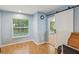 Cozy office space with natural light and a sliding door leading to another room at 11512 Yellow Birch Ct, New Port Richey, FL 34654