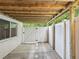 Covered patio with wooden support beams and a fenced-in area, offering privacy and shade at 11512 Yellow Birch Ct, New Port Richey, FL 34654