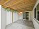 Covered patio features concrete flooring, a privacy fence and access to the interior via sliding glass doors at 11512 Yellow Birch Ct, New Port Richey, FL 34654