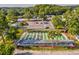 Aerial view of community shuffleboard courts with seating and palm trees at 11512 Yellow Birch Ct, New Port Richey, FL 34654
