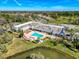 Aerial view of a community center featuring a pool, lounge chairs, and recreational facilities at 11601 Bayonet Ln # 163A2, New Port Richey, FL 34654