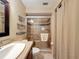 Bathroom with tiled walk-in shower with glass doors, dark wood vanity and neutral paint at 11601 Bayonet Ln # 163A2, New Port Richey, FL 34654