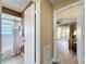 A view down a hall towards a full bathroom featuring tile shower and tub combination at 11601 Bayonet Ln # 163A2, New Port Richey, FL 34654