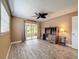 Bedroom featuring a ceiling fan, wood-look flooring, and slider doors to the screened in lanai at 11601 Bayonet Ln # 163A2, New Port Richey, FL 34654