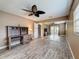 Spacious bedroom showcasing wood-look floors, ceiling fan, and mirrored closet doors at 11601 Bayonet Ln # 163A2, New Port Richey, FL 34654