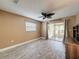 Cozy bedroom with modern ceiling fan, wood-look flooring, and sliding doors to screened porch at 11601 Bayonet Ln # 163A2, New Port Richey, FL 34654