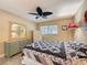 Bedroom featuring neutral walls, a ceiling fan, and a bed with unique floral designed quilt at 11601 Bayonet Ln # 163A2, New Port Richey, FL 34654