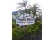 Welcoming sign for Pointe West Condominium Association surrounded by lush landscaping at 11601 Bayonet Ln # 163A2, New Port Richey, FL 34654