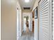 Bright hallway with wood-look flooring and multiple doorways leading to different rooms in the house at 11601 Bayonet Ln # 163A2, New Port Richey, FL 34654