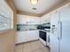 Efficient kitchen featuring white cabinetry and appliances for a clean, modern look at 11601 Bayonet Ln # 163A2, New Port Richey, FL 34654