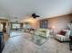 Bright living room featuring a full wall mirror, ceiling fan, and stylish furnishings at 11601 Bayonet Ln # 163A2, New Port Richey, FL 34654