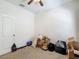 Bedroom includes neutral carpet, a ceiling fan, and is staged with moving boxes at 12248 Colony Lakes Blvd, New Port Richey, FL 34654