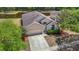 A single Gathering home with neutral paint, an attached garage and mature landscaping at 12248 Colony Lakes Blvd, New Port Richey, FL 34654