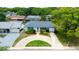 Aerial view of the home featuring a circular driveway and well-maintained landscaping at 12407 Gunstock Ln, Hudson, FL 34667