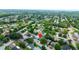 Breathtaking aerial view of a serene neighborhood with tree-lined streets and a tranquil pond at 12407 Gunstock Ln, Hudson, FL 34667