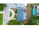 Birds-eye view of the house showcasing the roof, driveway, and proximity to nearby amenities and landscaping at 12407 Gunstock Ln, Hudson, FL 34667
