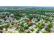 Aerial view showcasing a tranquil residential neighborhood with lush greenery and manicured lawns at 12407 Gunstock Ln, Hudson, FL 34667