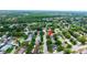 Wide aerial view of the neighborhood showcasing mature trees, various home styles, and well-maintained streets at 12407 Gunstock Ln, Hudson, FL 34667